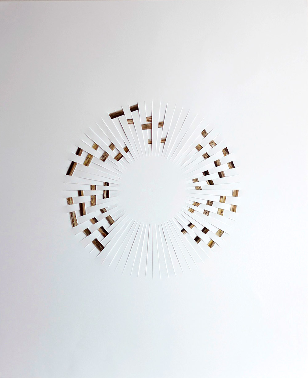 collage with strips of paper with printed wood texture, woven into a white paper background